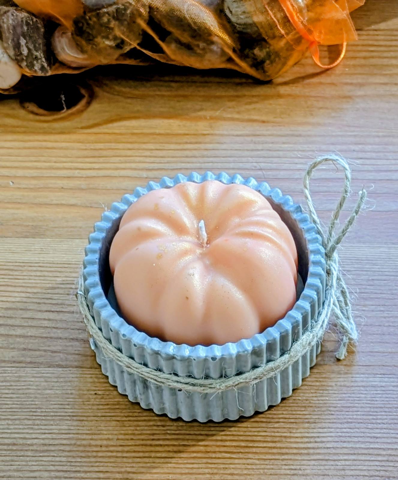Citrouille en cire de soja vue de dessus dans un bougeoir en plâtre cannelé